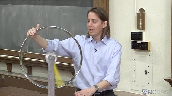 Image of professor Jason Hafner spinning a rotational device.