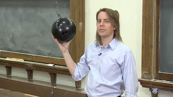 Image of professor Jason Hafner holding a wrecking ball.