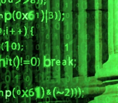 Image of Code in the Front and the Business Related Building in the Back