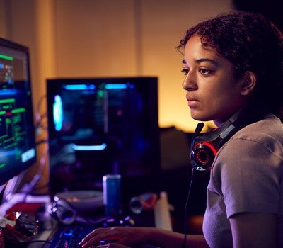 A woman with headphones on, deeply engaged in listening, showcasing a moment of concentration.